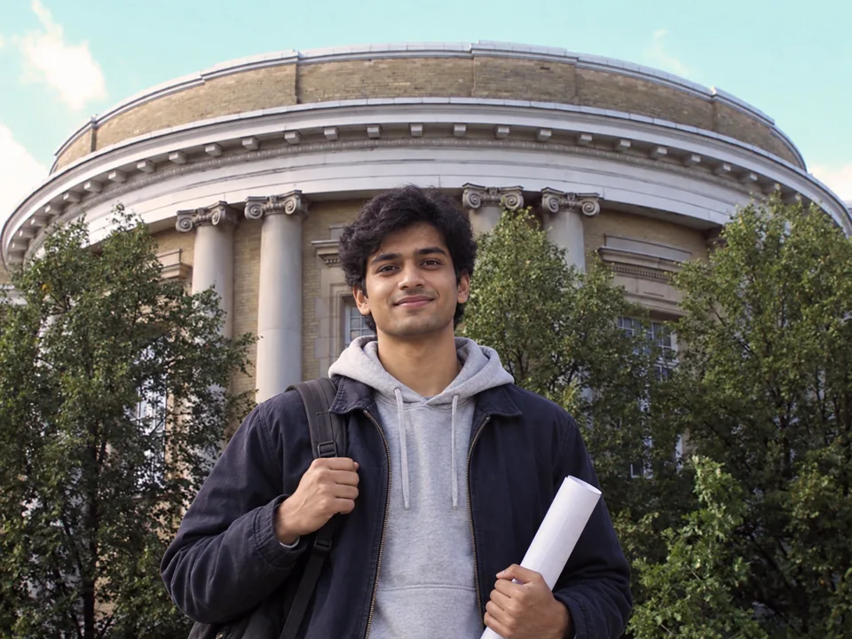 Indian engineering student in front of a University of Toronto building